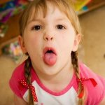 Child sticks out tongue at 3 years old